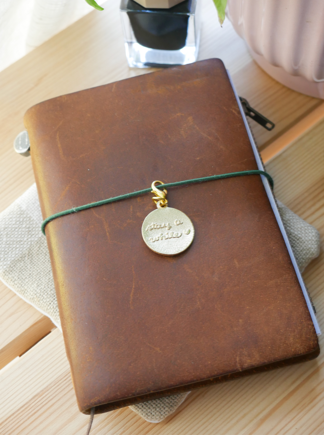 "stay a while" brass charm