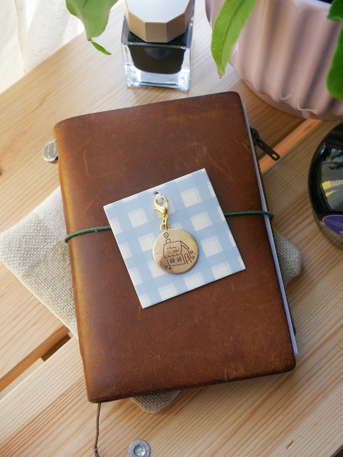 "stay a while" brass charm