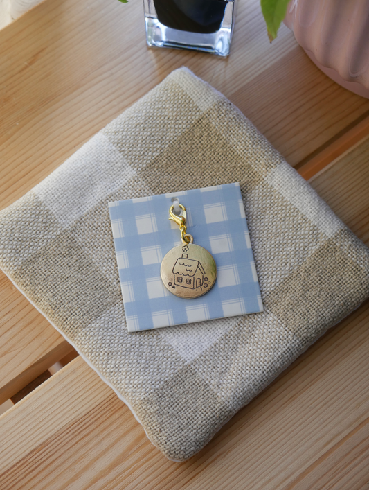 "stay a while" brass charm